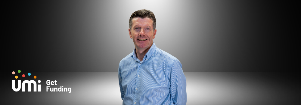 Image of Ian Henry standing under a spotlight
